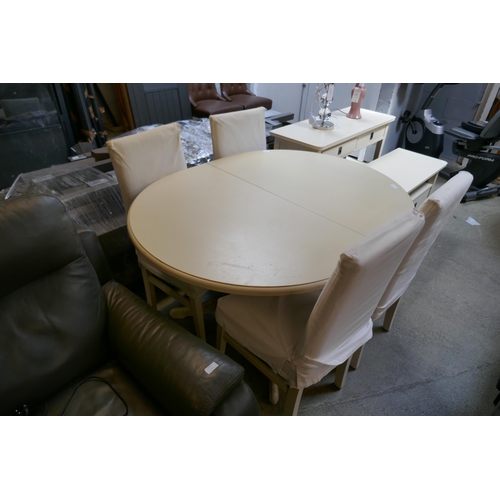 1600 - An off white extending dining table and four chairs