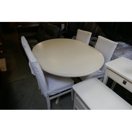 1600 - An off white extending dining table and four chairs