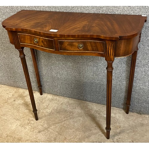 144 - A Regency style mahogany two drawer serpentine hall table table