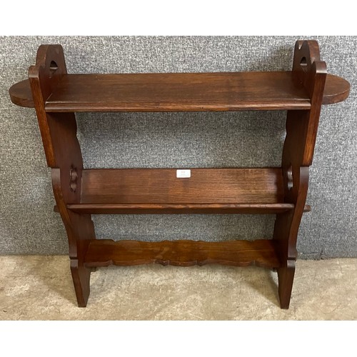 153 - An Arts and Crafts oak bookrack