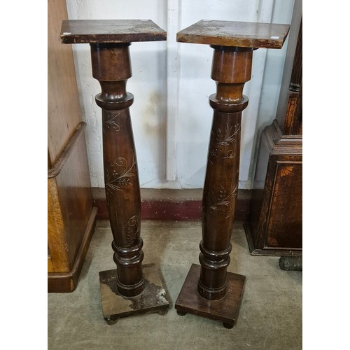 282B - A pair of Edward VII carved mahogany torcheres