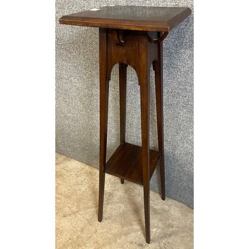 165 - An Arts and Crafts walnut jardiniere stand