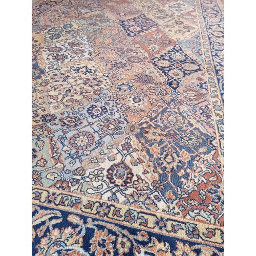 220 - An eastern blue ground patterned rug (300x200cm)