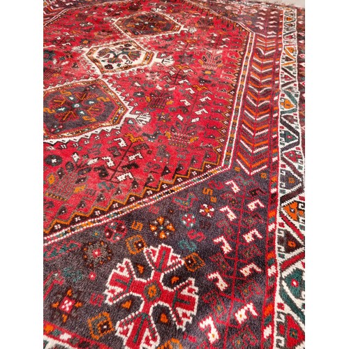 223 - An eastern red ground rug (190x160cm)