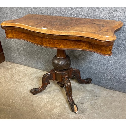 161 - A Victorian walnut and burr walnut serpentine fold over games table