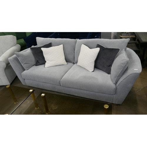 1322 - A grey velvet three seater sofa with contrasting scatter cushions