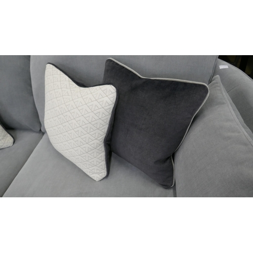 1322 - A grey velvet three seater sofa with contrasting scatter cushions