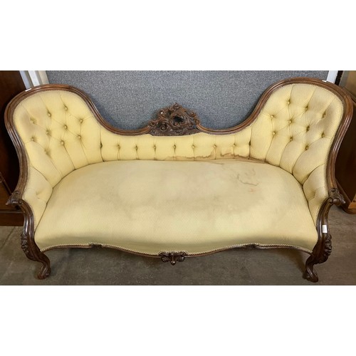 106 - A Victorian carved mahogany and fabric upholstered twin spoon back settee