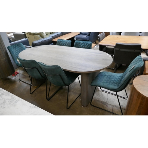 1423 - An oval grey wash dining table with brass detail and six emerald velvet chairs  *This lot is subject... 