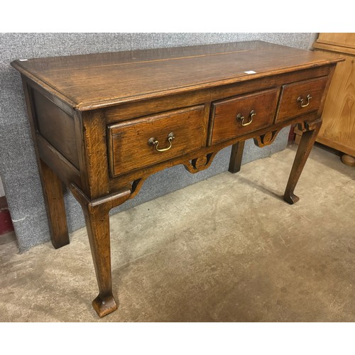 165 - A George II style oak three drawer dresser