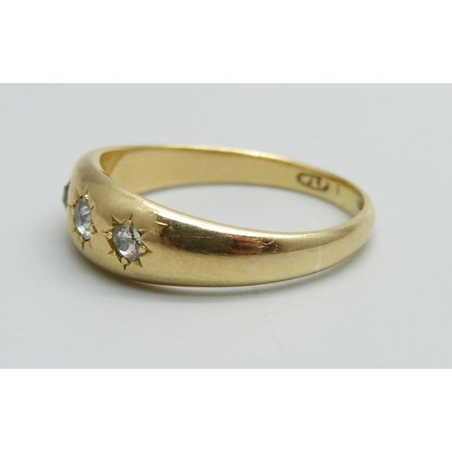 1011 - An 18ct gold and three stone diamond ring, 4.4g, O