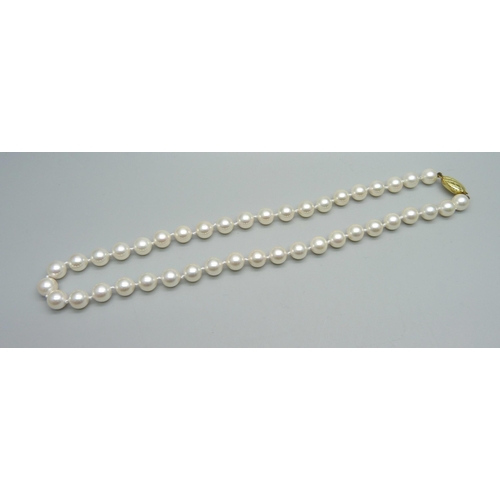 1015 - A faux pearl necklace with 9ct gold clasp