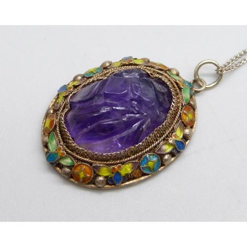 1044 - A Chinese carved amethyst and enamelled pendant on a silver chain, 22mm wide