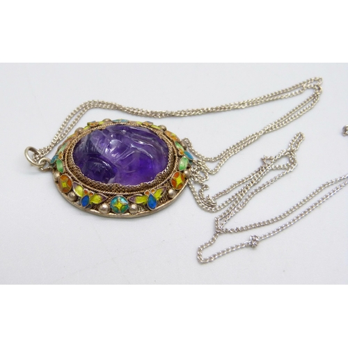 1044 - A Chinese carved amethyst and enamelled pendant on a silver chain, 22mm wide