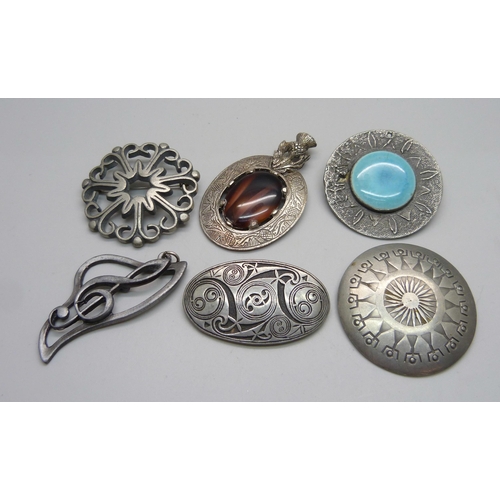 1049 - A Swedish pewter brooch by Erik Fransson, a St Justin pewter brooch, a Cornish pewter brooch, etc.