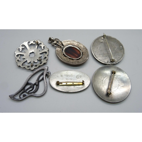 1049 - A Swedish pewter brooch by Erik Fransson, a St Justin pewter brooch, a Cornish pewter brooch, etc.