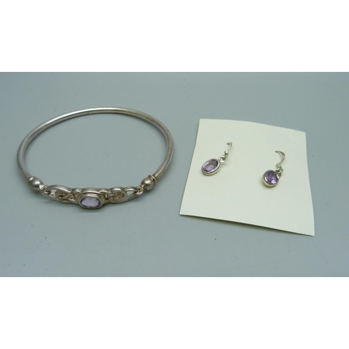 1070 - A silver and amethyst bangle, 10g and a similar pair of earrings