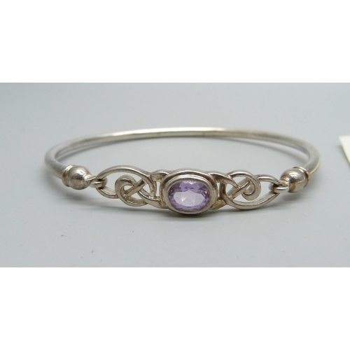 1070 - A silver and amethyst bangle, 10g and a similar pair of earrings