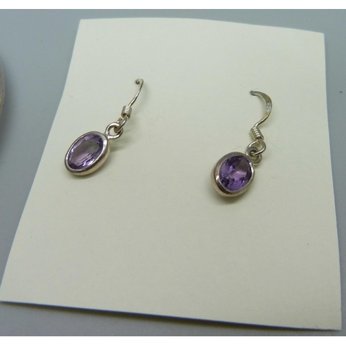 1070 - A silver and amethyst bangle, 10g and a similar pair of earrings