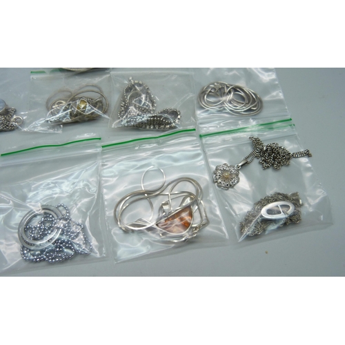 1073 - Twelve silver pendants and chains