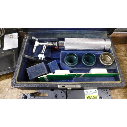 1097 - A green BT telephone, soldering iron and holder, a cased otoscope, a Brother P-Touch 750 label machi... 