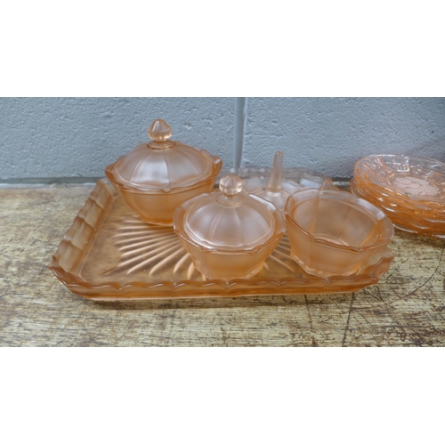 1118 - A peach glass dressing table set, six peach glass bowls and saucers and a pale blue glass dressing t... 