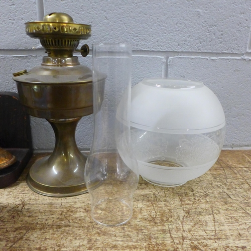 1128 - An Art Deco style biscuit barrel, a plated footed sweetmeat dish, a pair of bookends and an oil lamp... 