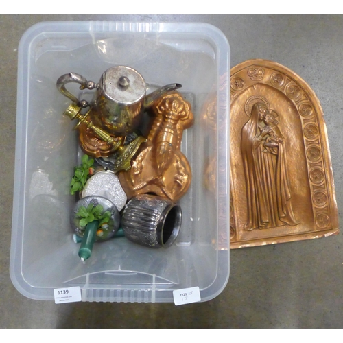 1139 - An embossed copper plaque depicting Madonna and child, three copper jelly moulds, a brass candlestic... 