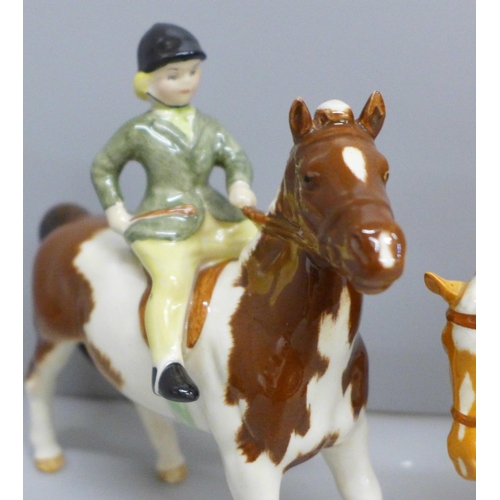 626 - Two Beswick ponies and riders; Girl on Skewbald pony and Boy on Palomino pony