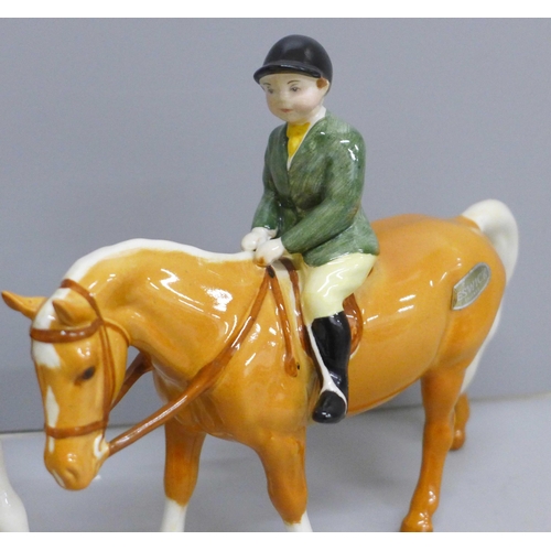 626 - Two Beswick ponies and riders; Girl on Skewbald pony and Boy on Palomino pony