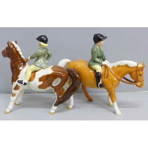 626 - Two Beswick ponies and riders; Girl on Skewbald pony and Boy on Palomino pony