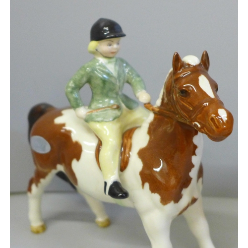 646 - Two Beswick ponies and riders; Girl on Skewbald pony and Boy on Palomino pony