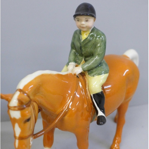 646 - Two Beswick ponies and riders; Girl on Skewbald pony and Boy on Palomino pony