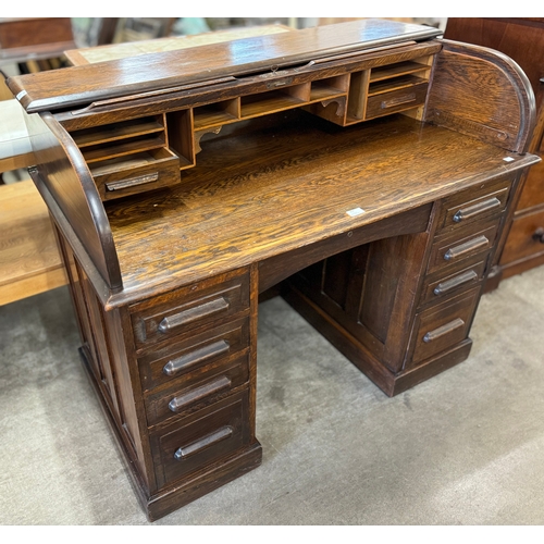 214 - An early 20th Century oak tambour roll top desk