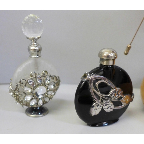 650 - A collection of scent bottles, glove stretchers, fobs and hat pins including glass examples
