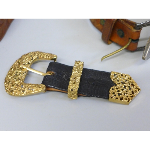 653 - A white metal belt buckle, leather belt, one other leather belt with plated buckle and a gilt metal ... 