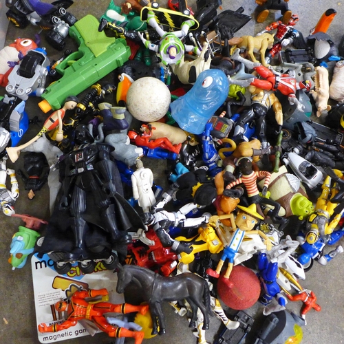 711 - A bag of various Transformer and other similar plastic toys