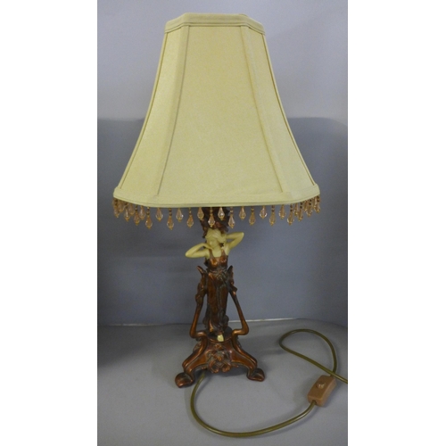 820 - A spelter figure, Marchande de Volailles and a figural Art Noveau style table lamp