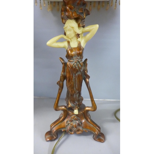 820 - A spelter figure, Marchande de Volailles and a figural Art Noveau style table lamp