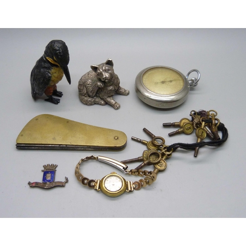 878 - A silver covered model cat, a nodding cold painted model bird, a fleam, watch keys, etc.