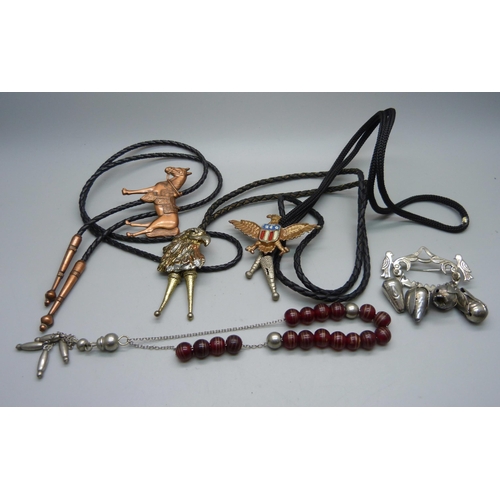 879 - A string of Tasbih prayer beads, a protection brooch, South America, and three Bolo ties