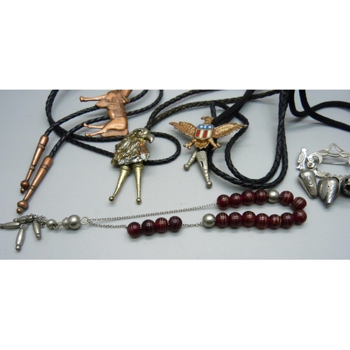 879 - A string of Tasbih prayer beads, a protection brooch, South America, and three Bolo ties