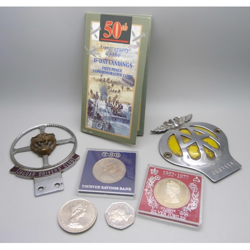 882 - A Jaguar Drivers' Club car badge, an AA badge and commemorative crowns and 50p pieces