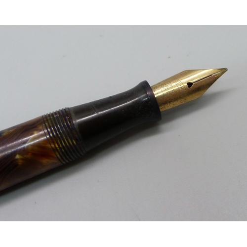 888 - A Waterman's Ideal flat top fountain pen with brown ripple barrel and green ripple cap