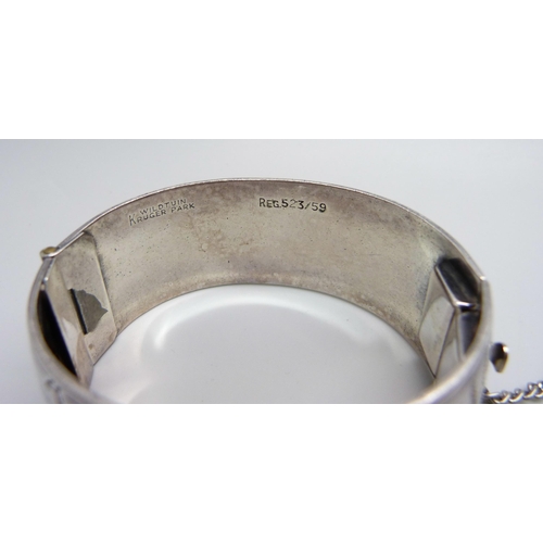 970 - A white metal bangle with African wild life detail, marked Wildtuin, Kruger Park, tests as silver, 6... 