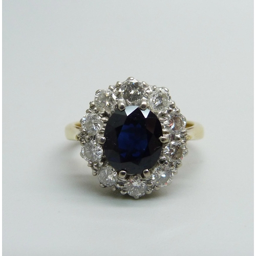 974 - An 18ct gold, sapphire and diamond cluster ring, 5.4g, M