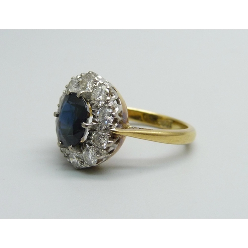 974 - An 18ct gold, sapphire and diamond cluster ring, 5.4g, M