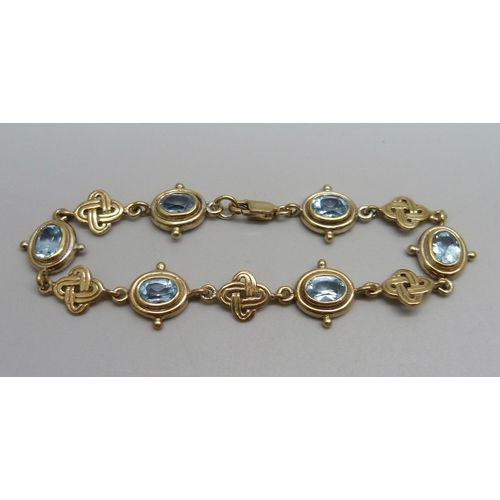 990 - A silver gilt aquamarine Celtic design bracelet