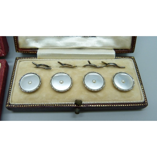 994 - A cased set of four 9ct gold and pearl buttons, 4.7g, and a set of three buttons