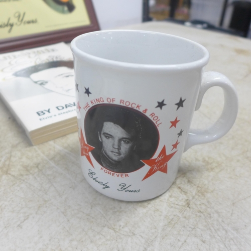 2054 - A quantity of Elvis Presley memorabilia including clocks, mugs, fridge magnets, books, magazines, sc... 